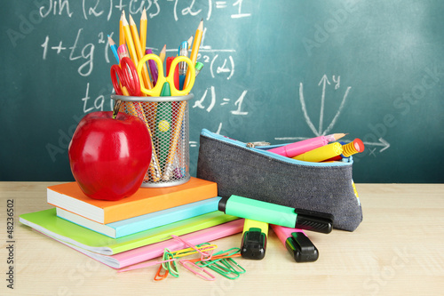 Photo: Back to school - blackboard with pencil-box and school Back to school - blackboard with pencil-box and school