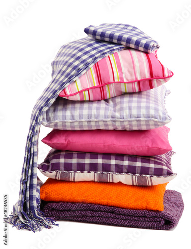 Photo: Hill colorful pillows and plaids isolated on white Hill colorful pillows and plaids isolated on white