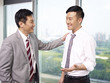 asian business people standing and talking in office