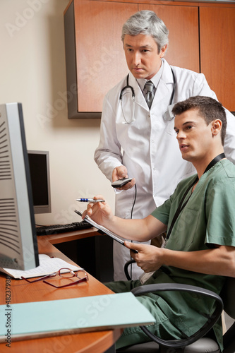 Photo: Technician And Doctor Working At Clinic Technician And Doctor Working At Clinic
