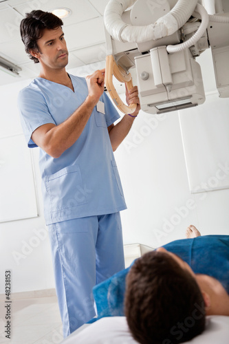 Photo: Technician Taking Patient's X-ray Technician Taking Patient's X-ray