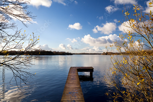 Photo: wooden pier on big lake in autumn wooden pier on big lake in autumn