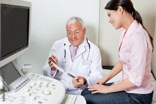 Photo: Radiologist Showing Ultrasound Print To Patient Radiologist Showing Ultrasound Print To Patient