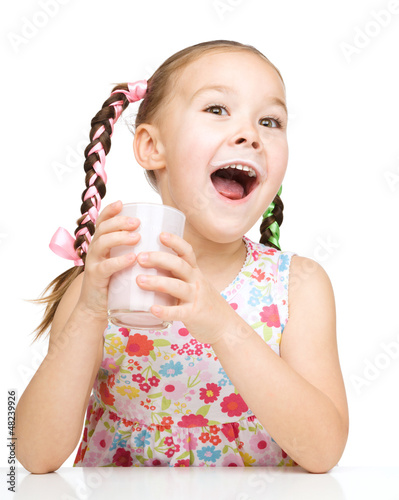 Photo: Cute little girl with a glass of milk Cute little girl with a glass of milk
