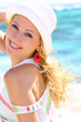 Attractive blond woman standing by the sea