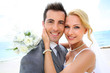 Portrait of beautiful bride and groom at the beach