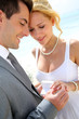Bride and groom exchanging wedding rings