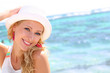 Beautiful girl wearing hat at the beach