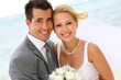 Cheerful married couple standing on the beach