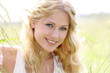 Portrait of beautiful blond girl in countryside