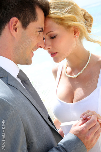 Photo: Bride and groom exchanging wedding rings Bride and groom exchanging wedding rings