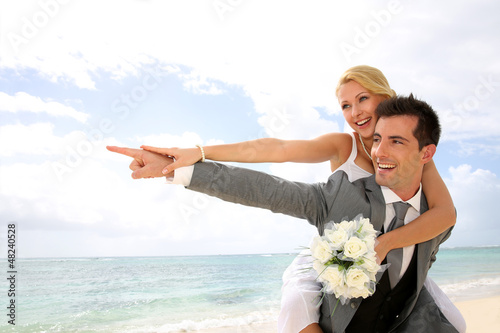 Photo: Honeymoon piggyback ride on the beach Honeymoon piggyback ride on the beach