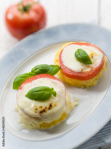 Photo: mozzarella tomatoes and porridge, selective focus mozzarella tomatoes and porridge, selective focus