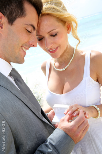 Photo: Bride and groom exchanging wedding rings Bride and groom exchanging wedding rings