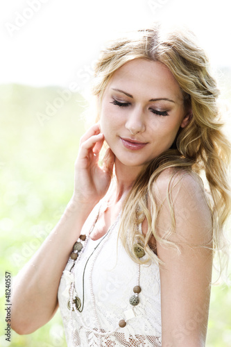 Photo: Beautiful blond girl in meadow Beautiful blond girl in meadow