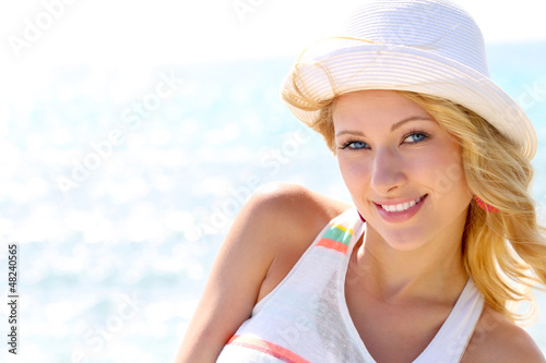 Photo: Closeup of beautiful girl at the beach Closeup of beautiful girl at the beach