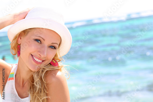 Photo: Beautiful girl wearing hat at the beach Beautiful girl wearing hat at the beach