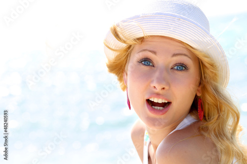 Photo: Closeup of beautiful girl at the beach Closeup of beautiful girl at the beach