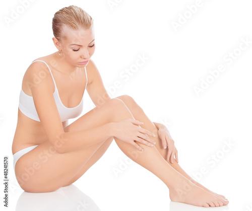 Photo: Woman in white underwear sitting on a floor Woman in white underwear sitting on a floor