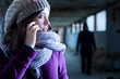 Photo: Worried Woman Stalked by a Man Worried Woman Stalked by a Man