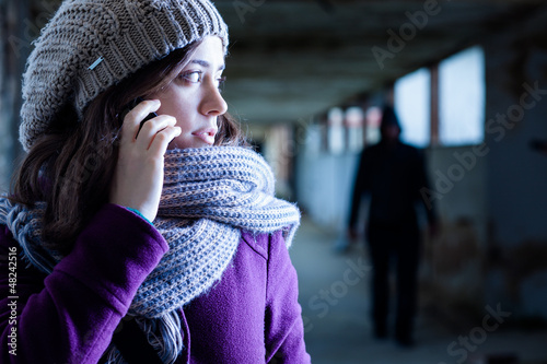 Photo: Worried Woman Stalked by a Man Worried Woman Stalked by a Man