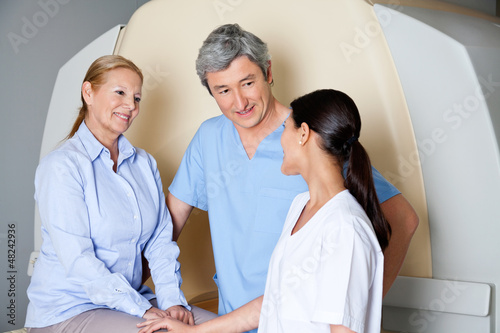 Photo: Technicians With Mature Female Patient Technicians With Mature Female Patient