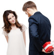 Foto: Man hides the present behind the back Man hides the present behind the back