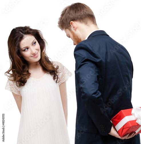 Photo: Man hides the present behind the back Man hides the present behind the back