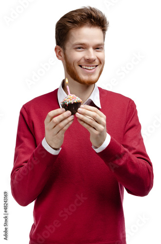 Photo: Man hands birthday tart with small candle in it Man hands birthday tart with small candle in it
