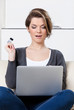 Beautiful woman makes bargains through the internet