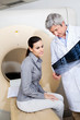 Radiologist Showing X-ray To Female Patient