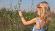 Little Girl Playing with Flowers on the Field