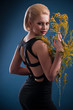 Photo: blonde woman with a branch blonde woman with a branch