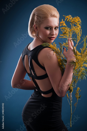 Photo: blonde woman with a branch blonde woman with a branch
