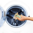 Photo: Crime Concept of Money Laundry: detail of a hand putting money Crime Concept of Money Laundry: detail of a hand putting money