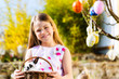 Child on Easter egg hunt with bunny