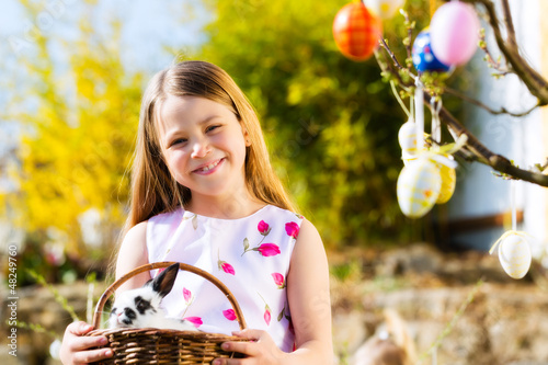Photo: Child on Easter egg hunt with bunny Child on Easter egg hunt with bunny