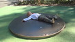 Child Spinning on a Merry-Go-Round, Little Girl Playing in Park