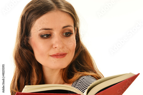 Photo: Young woman reading a book isolated on white Young woman reading a book isolated on white
