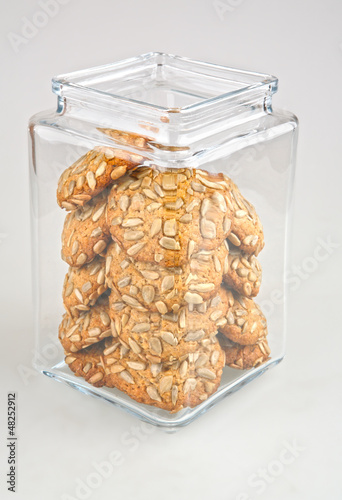 Photo: jar filled with cookie covered with seeds with clipping path jar filled with cookie covered with seeds with clipping path
