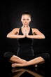 Woman performing yoga sitting on the floor