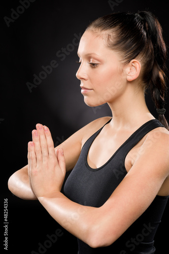 Photo: Tranquil woman performing yoga with eyes closed Tranquil woman performing yoga with eyes closed