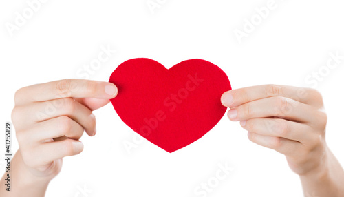 Photo: Two arms holding red fabric heart. Valentine's day or medical se Two arms holding red fabric heart. Valentine's day or medical se