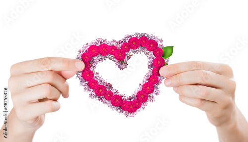 Photo: Two arms holding red fabric heart. Valentine's day concept Two arms holding red fabric heart. Valentine's day concept