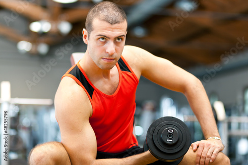 Photo: Man working out at the gym Man working out at the gym