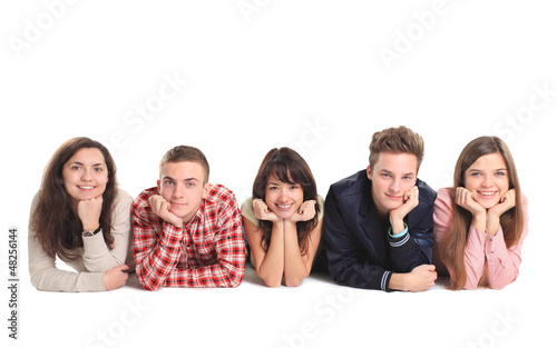 Photo: Group of people lying on the floor isolated over a white Group of people lying on the floor isolated over a white