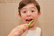 Cute boy washing his teeth