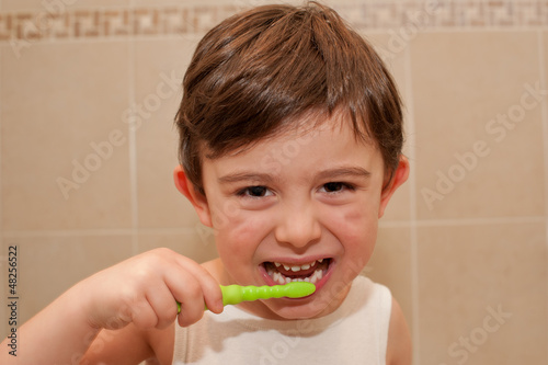 Photo: Cute boy washing his teeth Cute boy washing his teeth