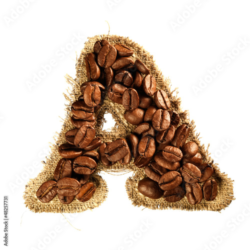 Photo: Alphabet from coffee beans on fabric texture isolated on white Alphabet from coffee beans on fabric texture isolated on white