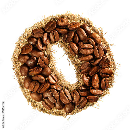 Photo: Alphabet from coffee beans on fabric texture isolated on white Alphabet from coffee beans on fabric texture isolated on white